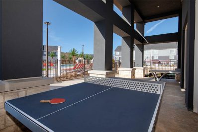 Ping pong table near resort-style pool