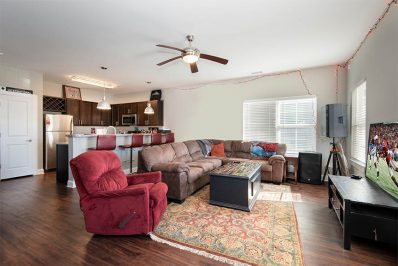 Open layout living room with a sofa, chairs, and coffee table