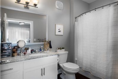Private bathroom with white vanity cabinets