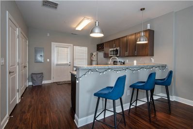 Open layout kitchen with blue countertop seating
