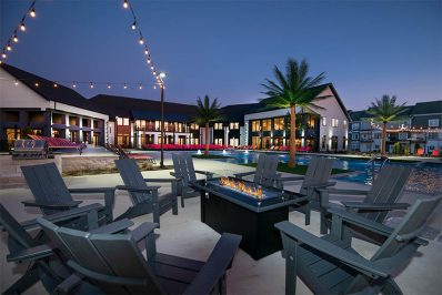Fire pit next to resort-style pool at night