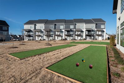 Areas of green and dirt surrounded by apartment buildings