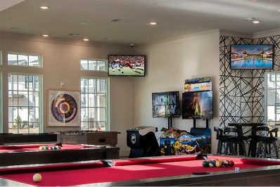 Game room with two pool tables, Video games, and a foosball table