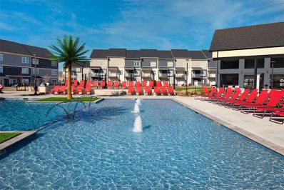 resort-style pool with red pool deck seating