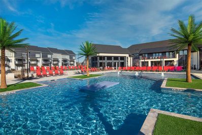 resort-style pool with red pool deck seating