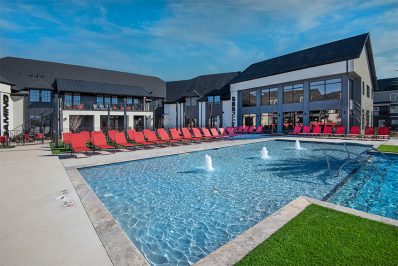 resort-style pool with red outdoor seating