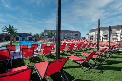 Red pool deck lounge seating surrounding resort-style pool